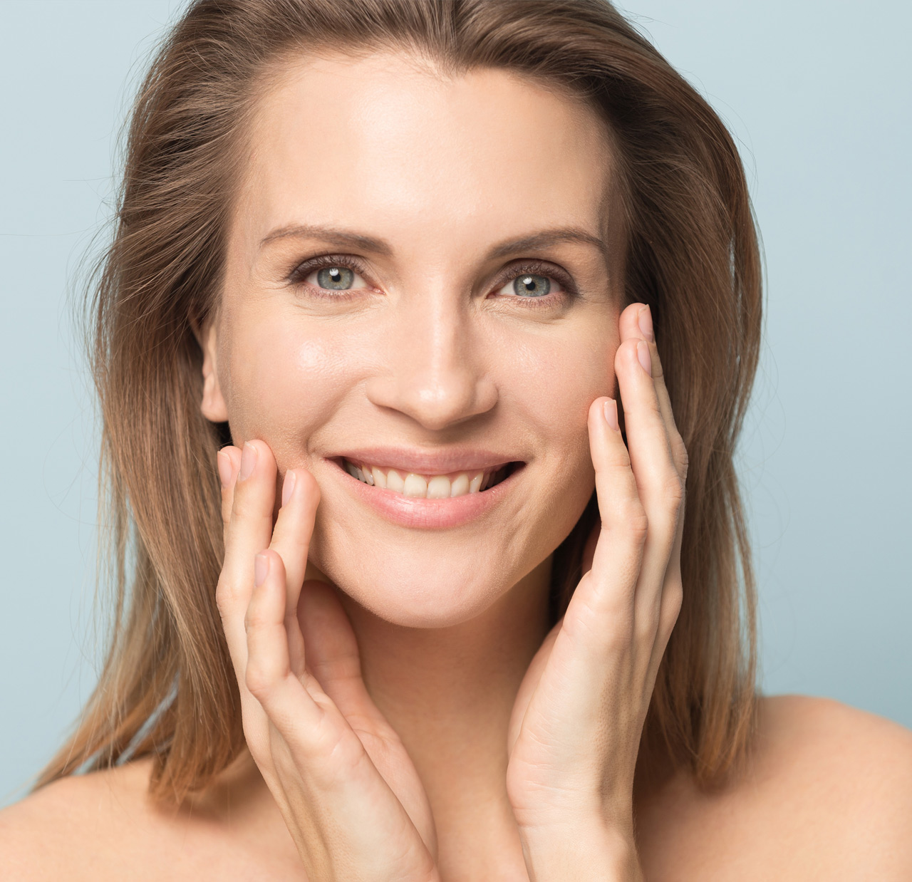 Head shot portrait smiling woman touching perfect smooth face skin