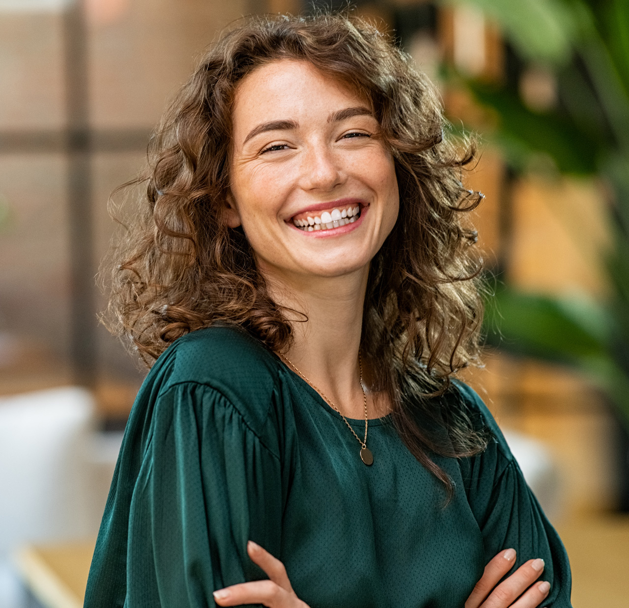 Beautiful woman smiling with crossed arms