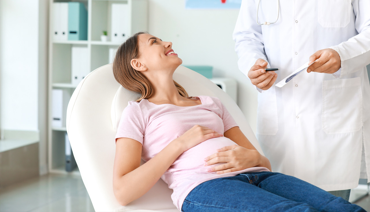 Male gynecologist working with pregnant woman in clinic Male gynecologist working with pregnant woman in clinic