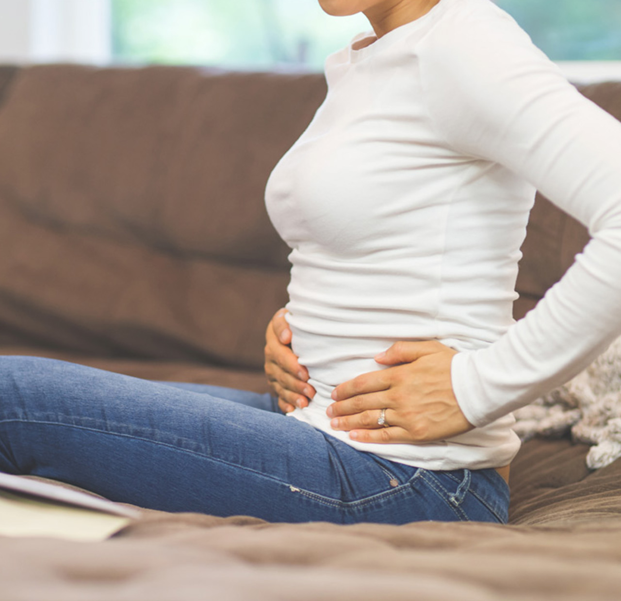 woman holding mid section and placing pressure