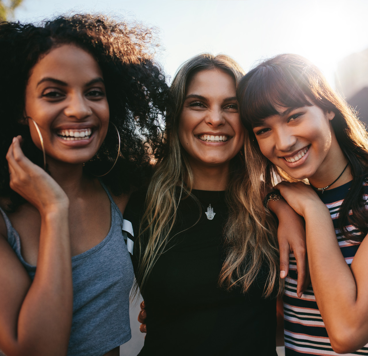 Three young women having fun on city street