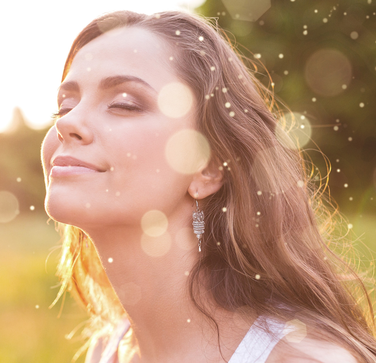 Young woman on field under sunset light Young woman on field under sunset light